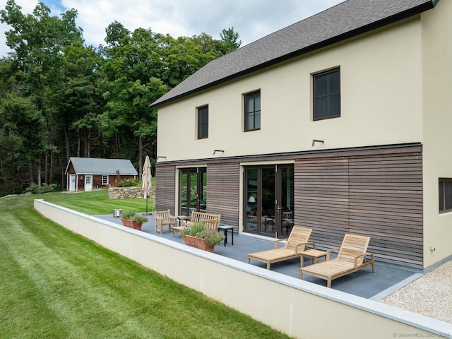 back of property featuring a lawn and a patio area