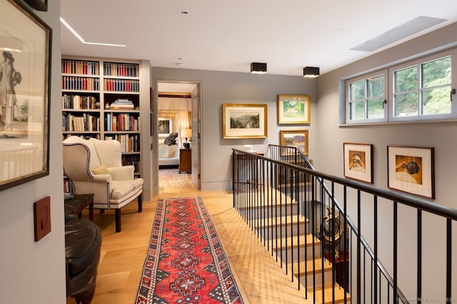 corridor with light hardwood / wood-style floors