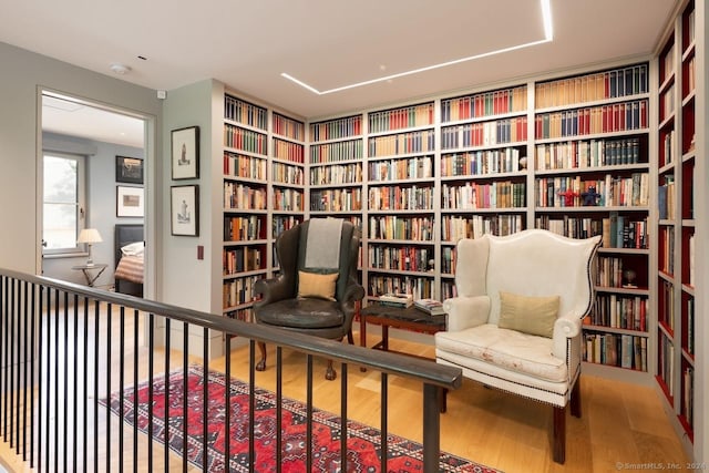 89 Under Mountain Rd, Canaan, CT 06031 - living area featuring bookshelves, wood finished floors, and built in features