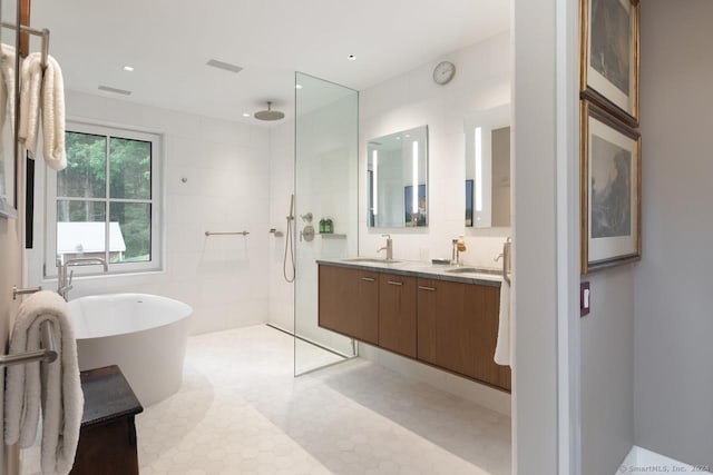 89 Under Mountain Rd, Canaan, CT 06031 - bathroom featuring walk in shower, double vanity, a freestanding bath, tile walls, and recessed lighting