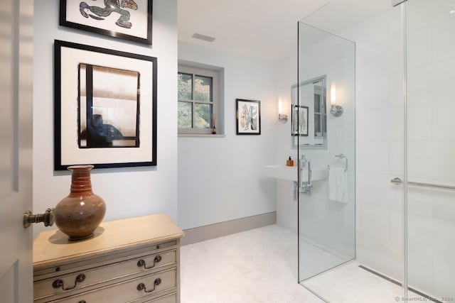 bathroom featuring walk in shower and vanity