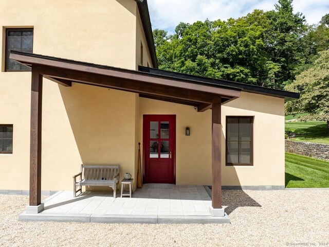 89 Under Mountain Rd, Canaan, CT 06031 - entrance to property with stucco siding and a patio area