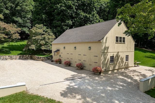 garage featuring wood walls and a yard