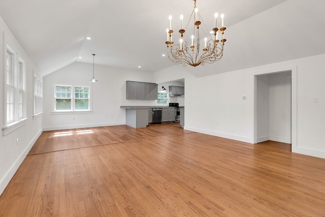 unfurnished living room with light wood-type flooring, a chandelier, and vaulted ceiling