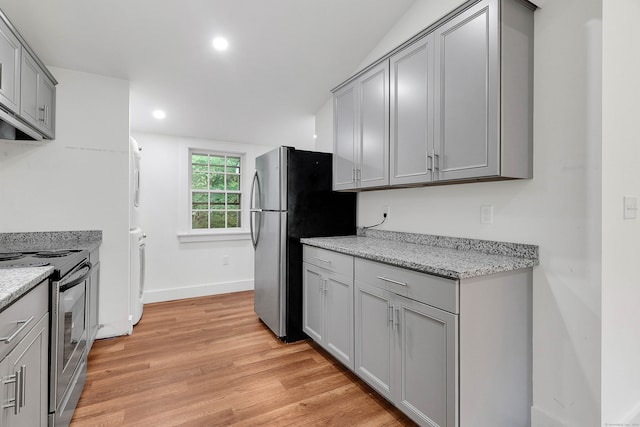 kitchen with stainless steel range with electric stovetop, light wood-type flooring, and gray cabinetry