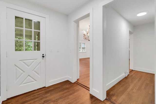 foyer featuring a chandelier and hardwood / wood-style flooring