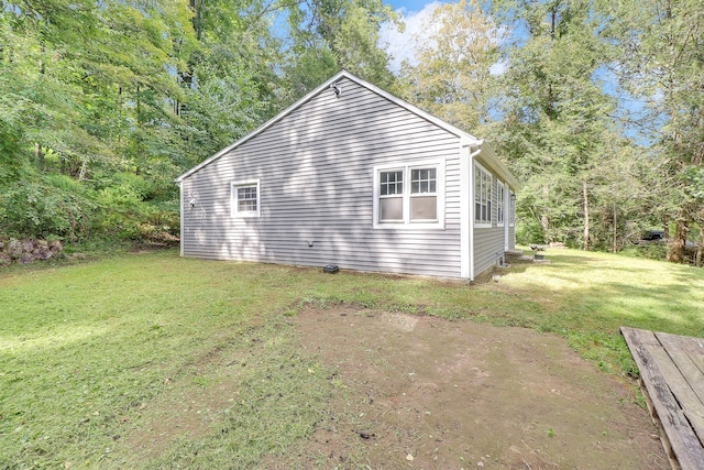 view of side of home with a lawn