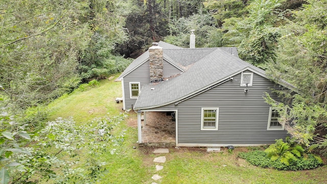 rear view of property featuring a lawn