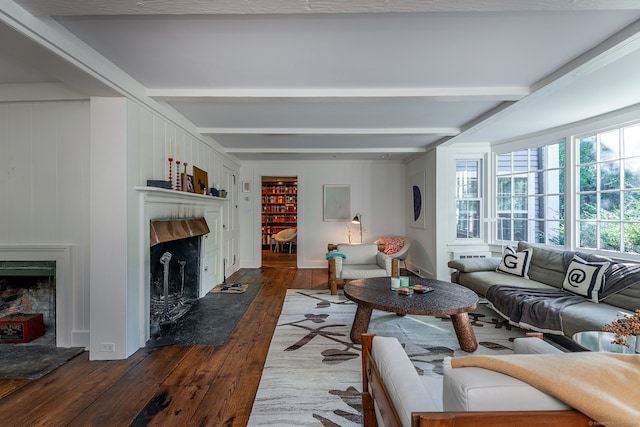 living room with beam ceiling, a premium fireplace, and dark hardwood / wood-style floors