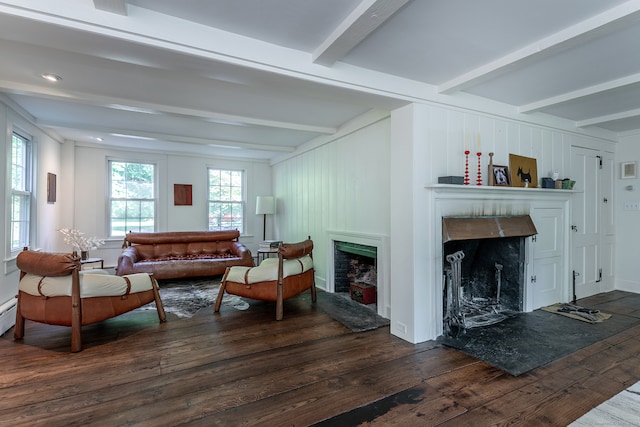 living room with beam ceiling and dark wood-type flooring