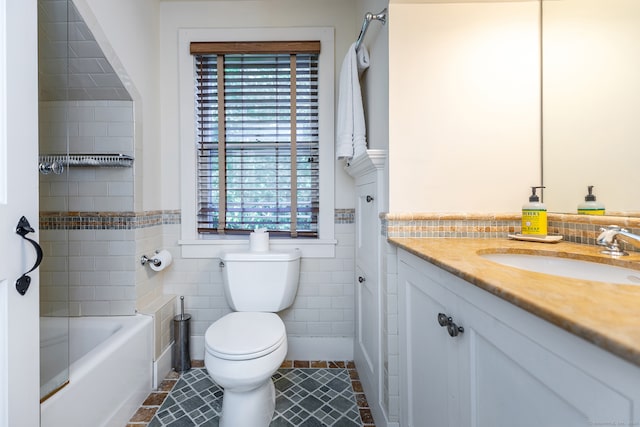 full bathroom with toilet, tile patterned floors, tile walls, vanity, and tub / shower combination