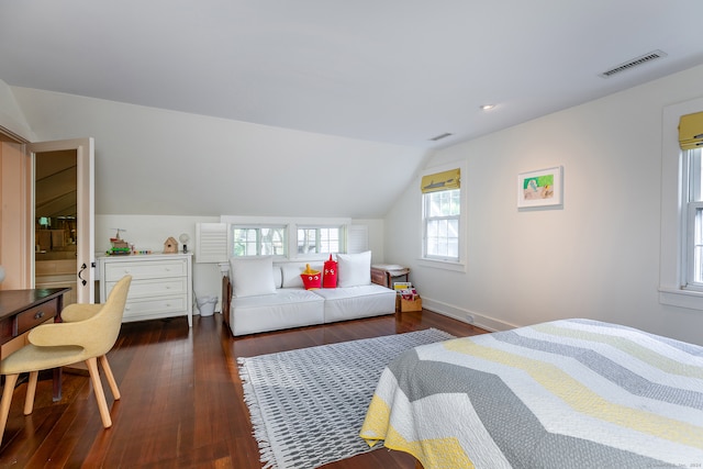 bedroom with vaulted ceiling and dark hardwood / wood-style flooring