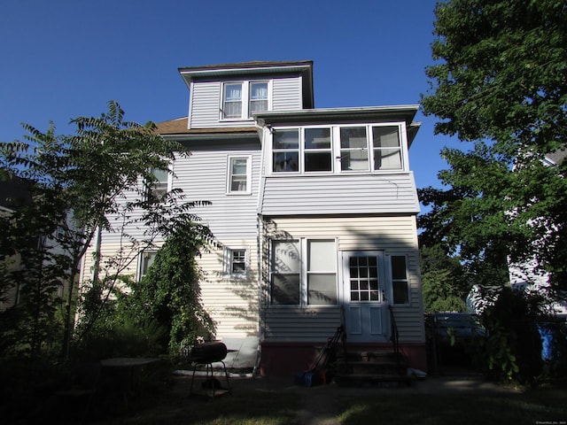 back of house featuring a sunroom