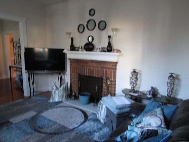 living room with a brick fireplace