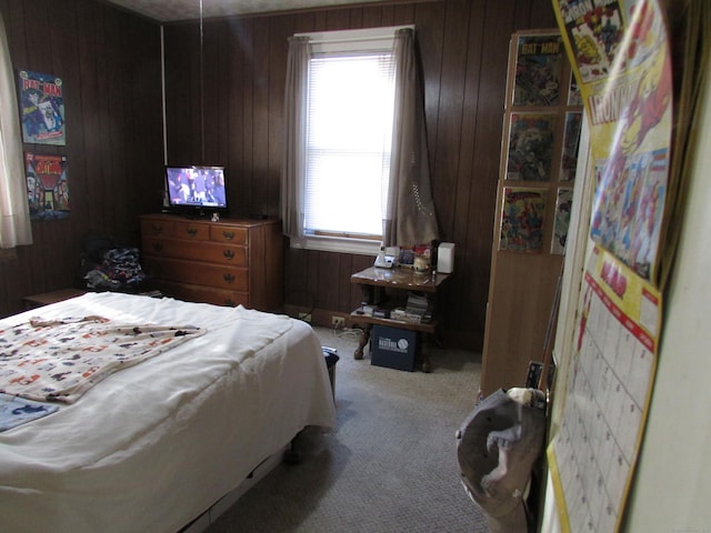 bedroom featuring carpet flooring and wooden walls