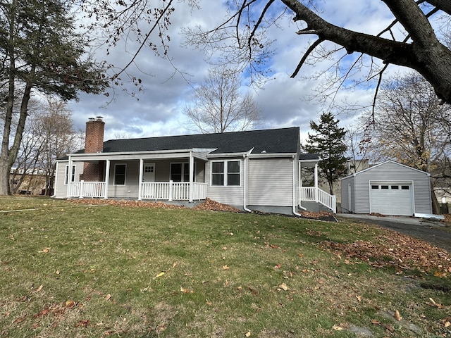 view of front facade featuring a porch, a garage, a front lawn, and an outdoor structure