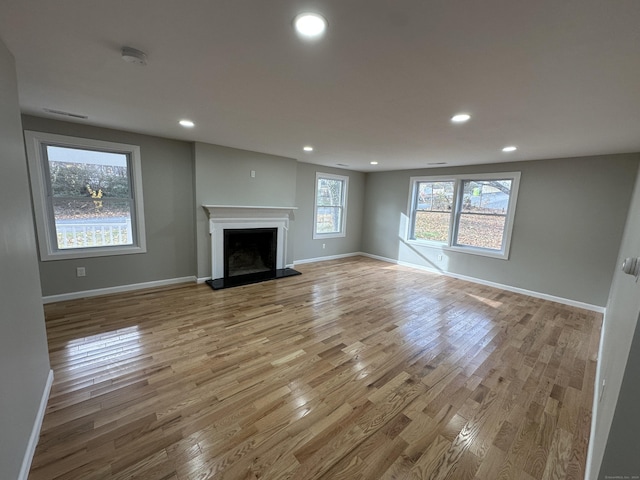 unfurnished living room with light hardwood / wood-style flooring