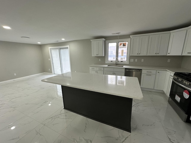 kitchen with white cabinets, sink, stainless steel dishwasher, a kitchen island, and black range with gas cooktop