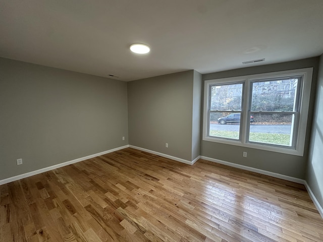 empty room with light hardwood / wood-style flooring