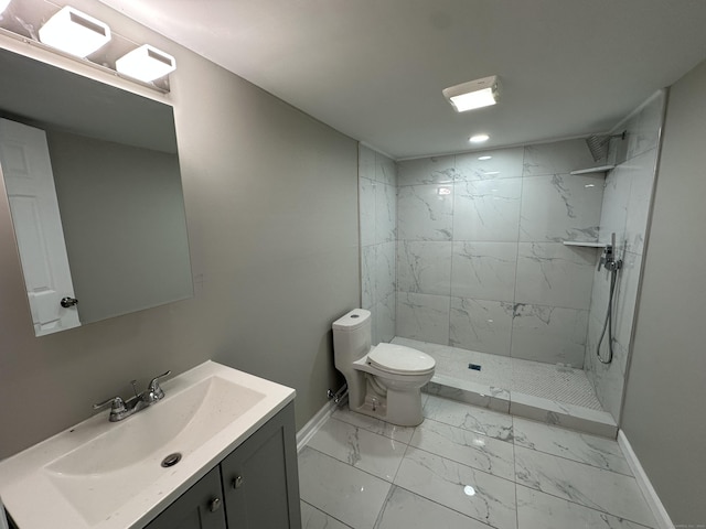 bathroom with vanity, toilet, and a tile shower