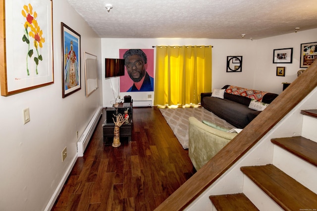 interior space featuring a textured ceiling, dark hardwood / wood-style flooring, and baseboard heating