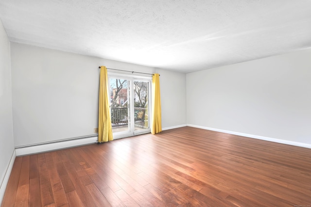 empty room with dark wood-type flooring, a baseboard radiator, a textured ceiling, and baseboards