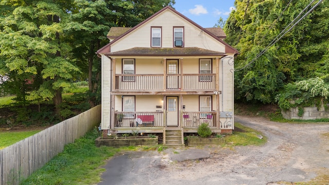 view of front of home featuring covered porch and a balcony