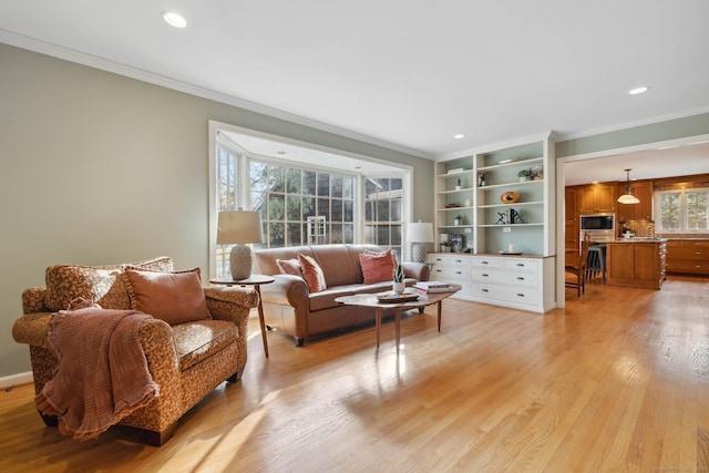 living room with light hardwood / wood-style flooring and ornamental molding