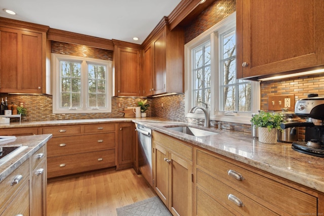 kitchen featuring stainless steel dishwasher, decorative backsplash, light stone countertops, and sink