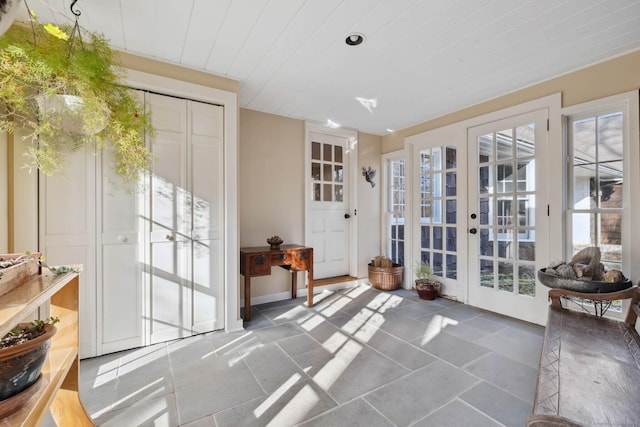 doorway with wooden ceiling, a wealth of natural light, and french doors