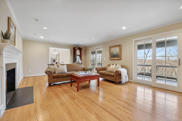 living room with crown molding and light hardwood / wood-style floors