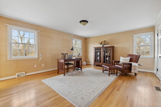 home office with crown molding and light wood-type flooring