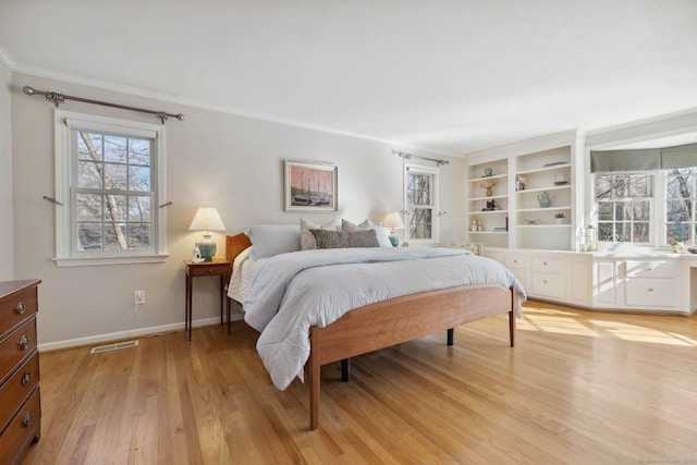 bedroom with crown molding and light hardwood / wood-style flooring