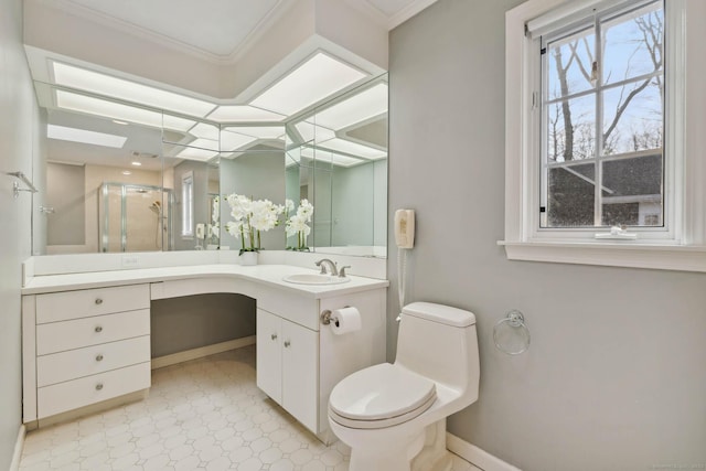 bathroom featuring vanity, toilet, a shower with door, and crown molding