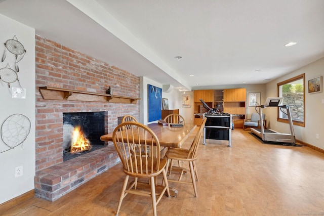 dining area featuring a fireplace and light hardwood / wood-style flooring