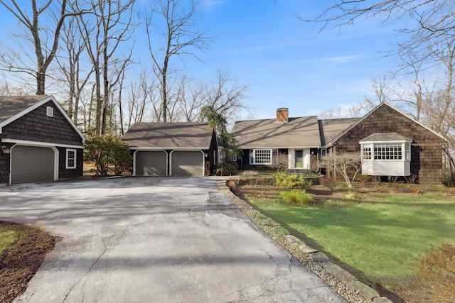 ranch-style home with a front lawn and a garage