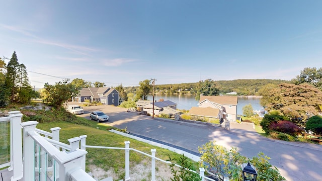 exterior space featuring a water view and a residential view