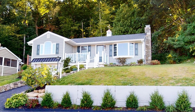 ranch-style home with a front lawn and a chimney