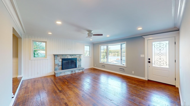 unfurnished living room with crown molding, dark wood-style floors, and a wealth of natural light