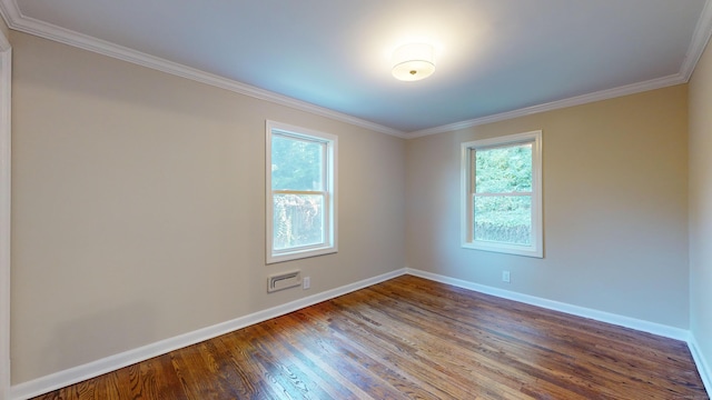 spare room with baseboards, ornamental molding, and dark wood-style flooring