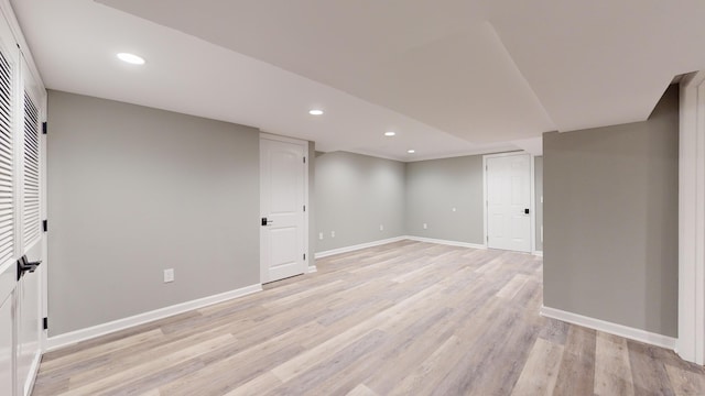 finished basement with recessed lighting, baseboards, and light wood-style flooring