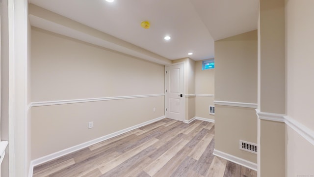 spare room featuring visible vents, recessed lighting, baseboards, and wood finished floors
