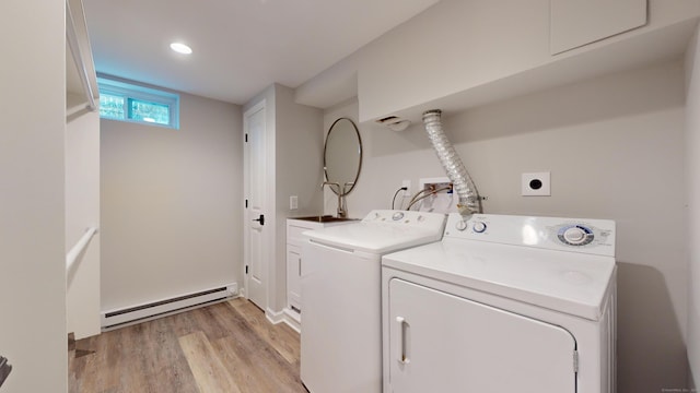 washroom featuring washer and dryer, light wood-style floors, recessed lighting, a baseboard radiator, and cabinet space