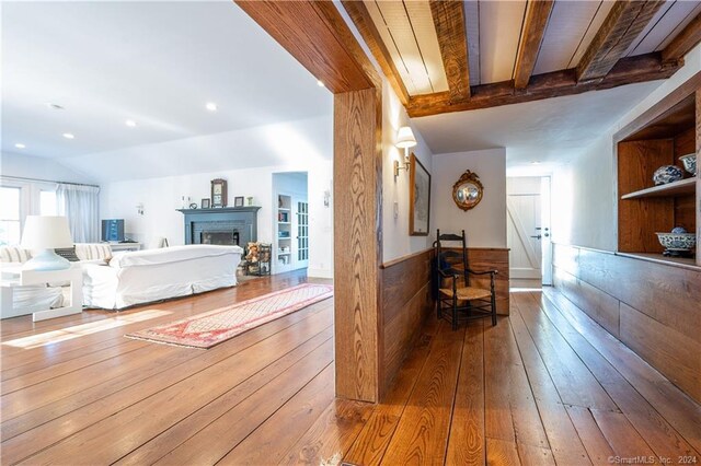 interior space with beamed ceiling and wood-type flooring