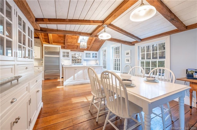 dining area featuring wood ceiling, light wood-type flooring, and vaulted ceiling with beams