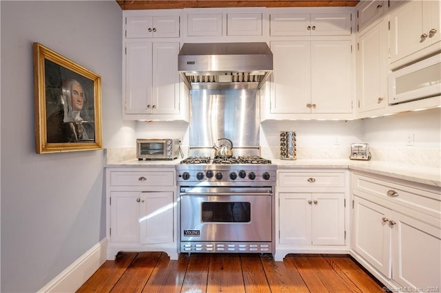 kitchen featuring wall chimney range hood, white cabinets, luxury stove, and dark hardwood / wood-style flooring