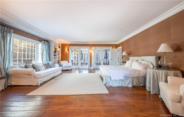 bedroom featuring dark wood-type flooring, french doors, access to outside, and ornamental molding