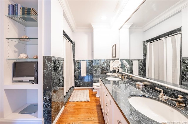 bathroom with toilet, ornamental molding, vanity, wood-type flooring, and a shower with curtain