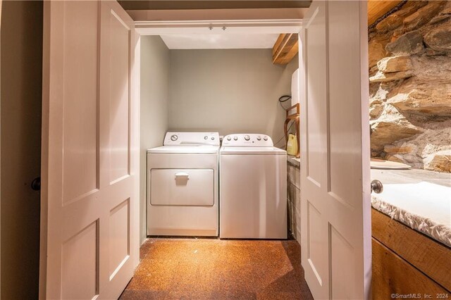 clothes washing area featuring washing machine and clothes dryer