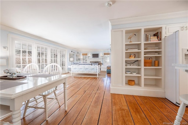 interior space featuring light wood-type flooring and built in shelves